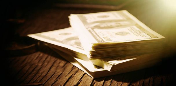 Close up stacks of US Dollar bills as a symbol of business, profit and money. Retro styled horizontal image. - Фото, изображение