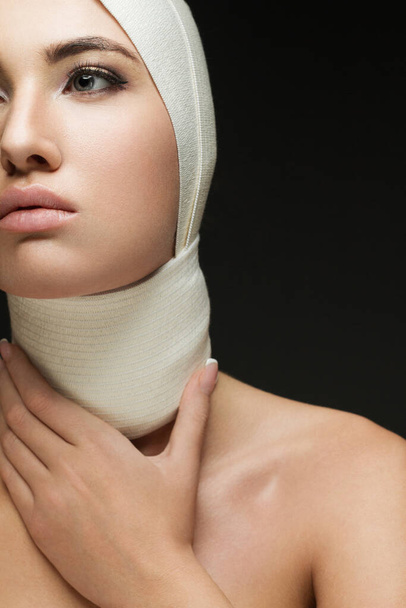 A beautiful woman after plastic surgery with bandaged face. Beauty, Fashion and Plastic Surgery concept - Foto, Bild