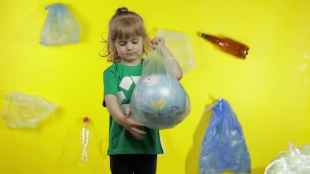 Girl activist makes Earth globe free from plastic package. Reduce trash pollution. Save ecology - Footage, Video