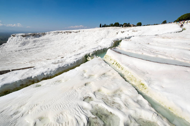 Thermal springs of Pamukkale with terraces and natural pools in Denizli in southwestern Turkey - Фото, изображение