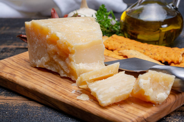 Traditional italian food - 36 months aged in caves Italian parmesan hard cheese from Parmigiano-Reggiano, Italy - Photo, Image