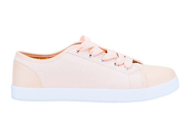 zapatillas de deporte de lona rosa para mujer zapatos cómodos sobre un fondo blanco
 - Foto, imagen