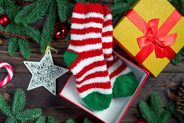 Striped christmas socks in a box. Christmas and gift concept objects - Photo, Image