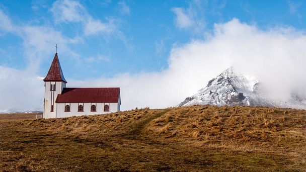 Hellnar church and the volcano Snaefellsjokull, covered in snow in Snaefellsnes peninsula of Western Iceland. - Photo, Image