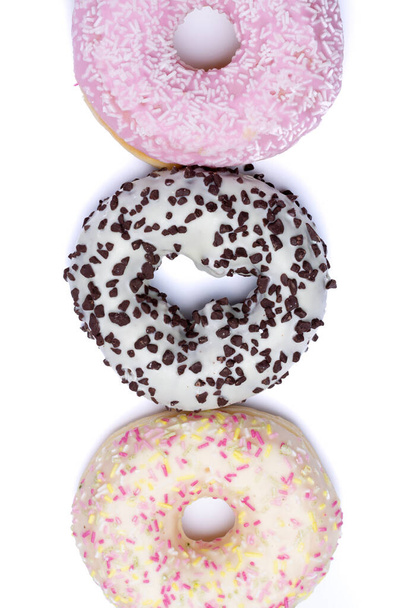 Copy space isolated colorful sweet glazed donuts on white background close up - Photo, Image