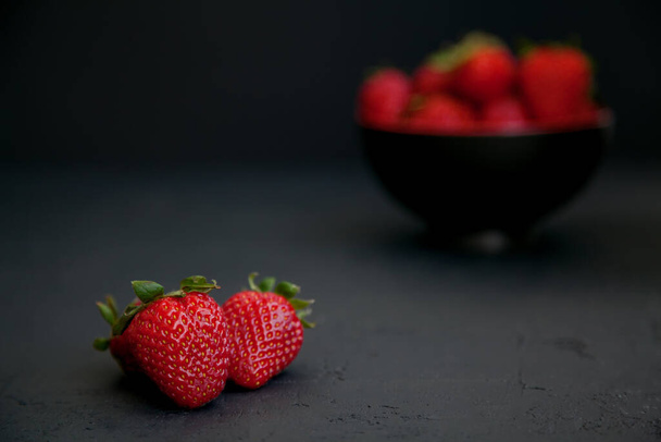 Red fresh juicy strawberries on a black background - Photo, image