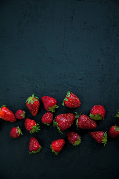 Juicy red strawberries on a black background, flat lay, copy-space - Photo, image