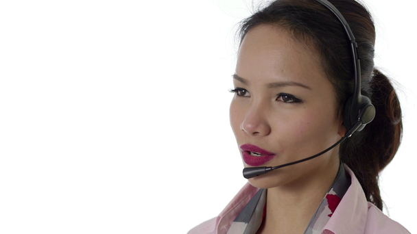Asian woman working as call center operator with headphones - Felvétel, videó