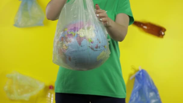 Unrecognizable woman with Earth globe in plastic package. Save ecology. Plastic nature pollution - Footage, Video