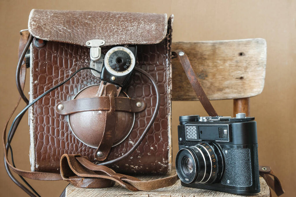 Film camera and leather bag with flash isolated. Old photography technology. - Foto, immagini