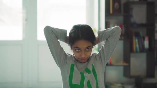 Children, celebration, birthday, large families, games and entertainment concept - a dark-skinned Persian girl of a Middle Eastern appearance teenager faints and falls to the floor against the window - Materiał filmowy, wideo
