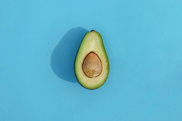avocado on a colored background food pattern - Фото, изображение