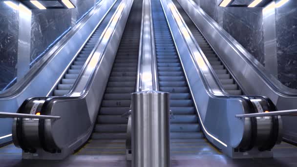 Escalator at the metro station. Escalator in the subway. Empty moving staircase running up and down. Modern escalator stairs, which moves indoor. - Footage, Video