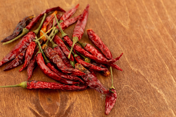 dried hot red pepper bunch on wooden background seasoning - Photo, Image