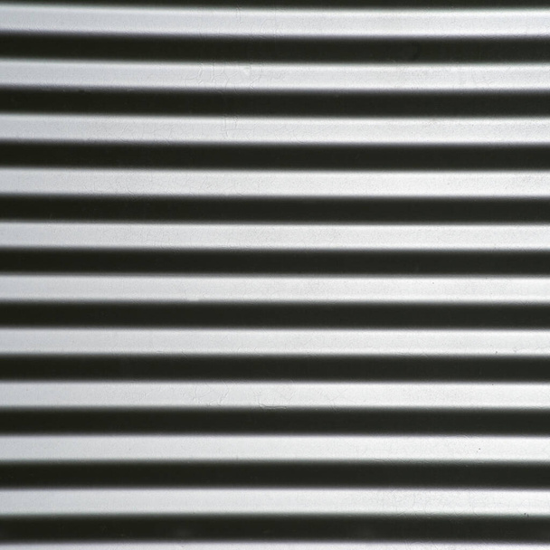 Fabricated corrugated steel reflects light, looks like steel bars that pop off the screen, machined grain dryer background abstract wallpaper negative copy space vivid eye-catching. Strength noir concepts law industry Turn 90 deg. for vertical bars - Photo, Image