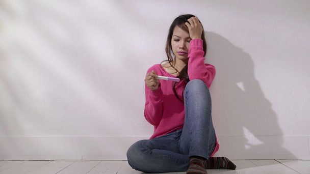 Asiatique fille regardant kit de test de grossesse
 - Séquence, vidéo