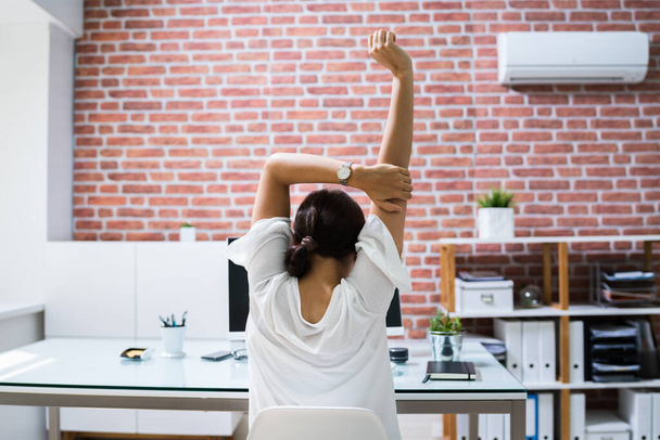 Woman Employee Doing Stretch Yoga Workout Exercise - Фото, изображение