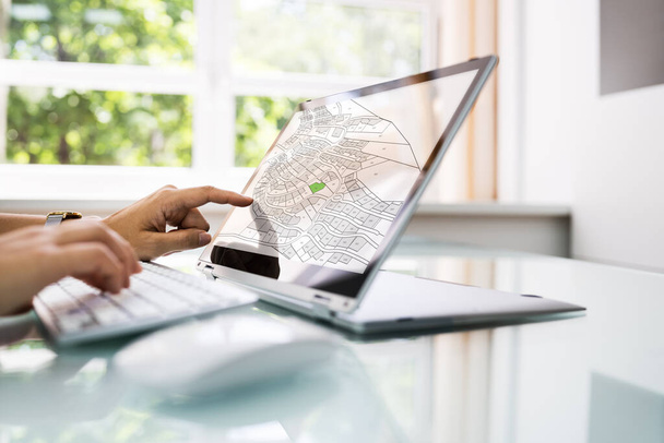 Female Executive Looking At Cadastre Map On Screen - Photo, Image