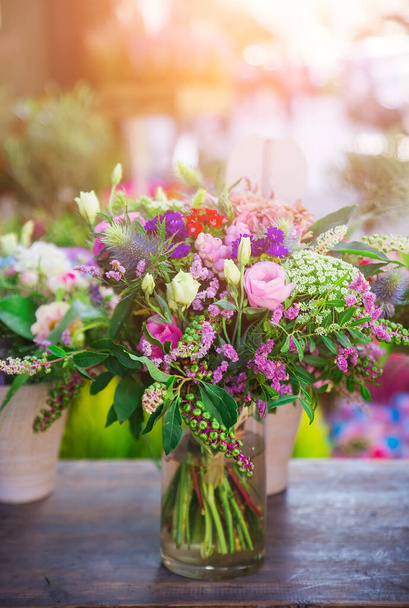 Beautiful flowers in a vase with selective focus on a Paris street in a cafe - 写真・画像