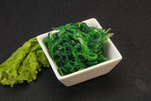 Green Chuka Seaweed Salad Isolated on White Background Top View (англійською). Wakame Sea Kelp Salat, Chukka Sea Weed, Healthy Algae Food - Фото, зображення