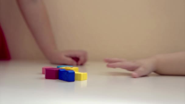 the child plays with wooden figures: shapes, numbers and colors. Details of the toy in the hands. Concept of development of fine motor skills, educational games, childhood, of, children's day, kindergarten. copyspace - Záběry, video