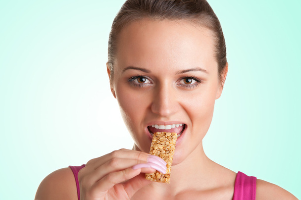Woman Eating a Cereal Bar - Zdjęcie, obraz
