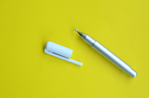 top view of the stylus pen on yellow background - 写真・画像