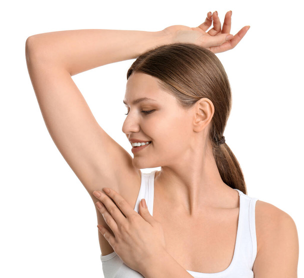 Young beautiful woman showing armpit with smooth clean skin on white background - Φωτογραφία, εικόνα