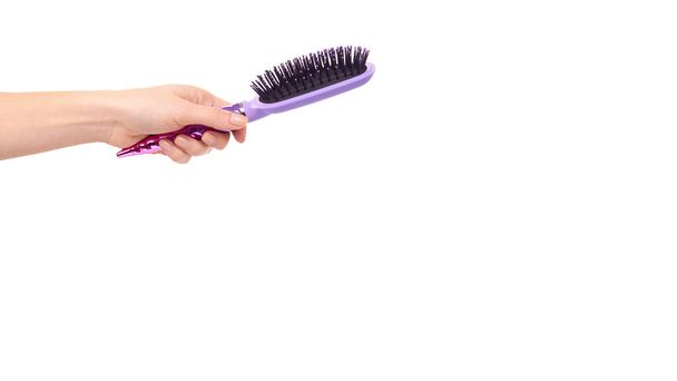 Hand with purple hairbrush, hair care and beauty. Isolated on white background. Copy space, template. - Фото, изображение