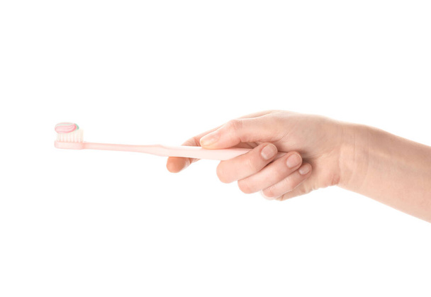Female hand with toothbrush and paste on white background - Photo, Image