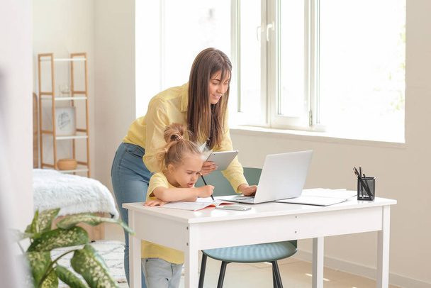 Working mother with her little daughter at home - Photo, Image
