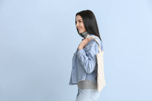 Young woman with eco bag on color background - Photo, Image