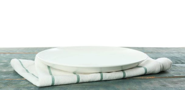 Empty plate and napkin on blue wooden table against white background - Valokuva, kuva