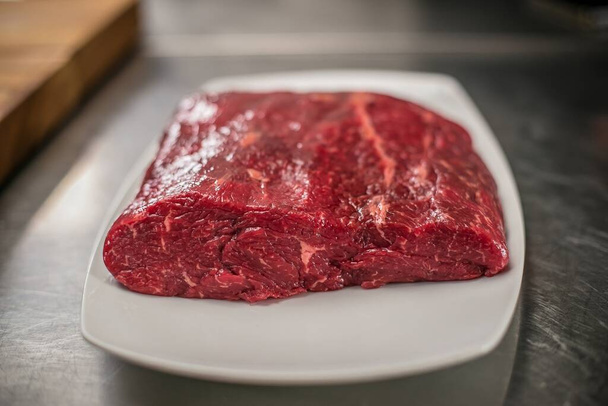 A closeup shot of a raw beef piece on the table - Fotoğraf, Görsel