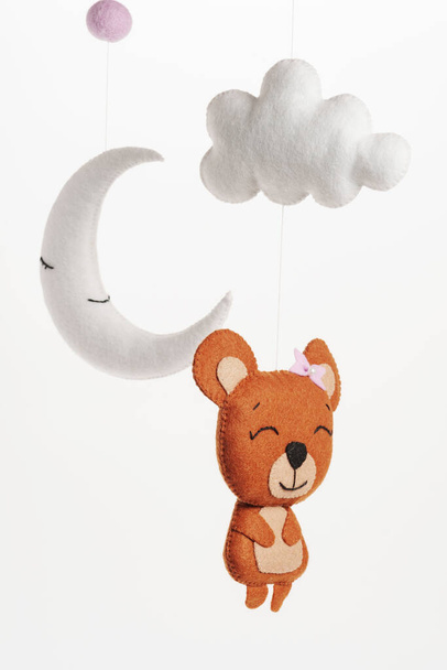 Colorful and eco-friendly children's mobile from felt for children. It consists of bear, moon and cloud toys. Handmade on white background. - Photo, Image