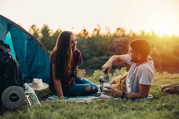 friends on camping outdoor by the river enjoying coffee - Φωτογραφία, εικόνα