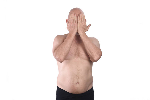 shirtless man cover his face on white background - Фото, зображення