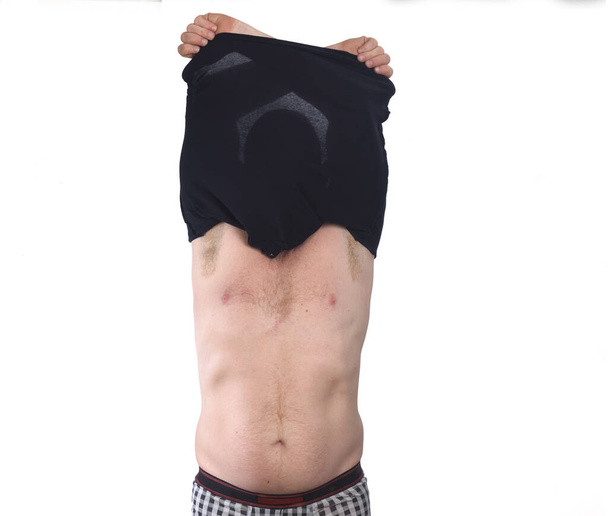 front view of a man undressed off his shirt on white background - Photo, Image
