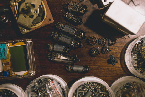 Electronic vacuum tubes and other electronic components on the table. Toned background for design. - Foto, imagen