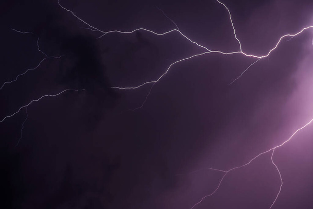 Lightning thunderstorm flash over the night sky. - Photo, Image