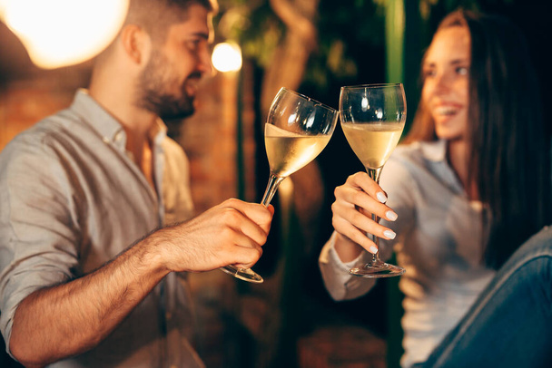romantic couple drinking wine on backyard decking . evening scene - Foto, immagini