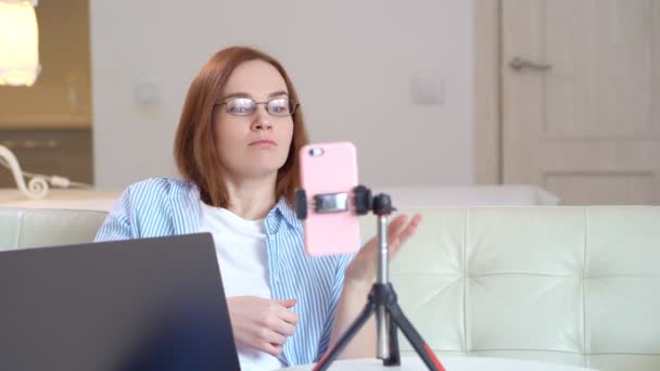 woman in glasses teaches conducts live, record webinar. social distance. - Materiał filmowy, wideo