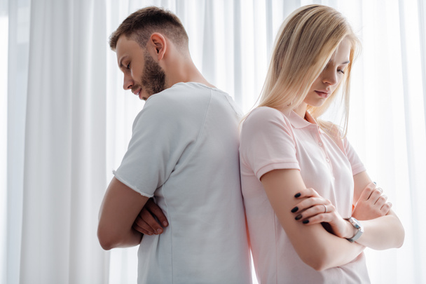 upset man and woman standing with crossed arms, relationship difficulties concept  - Фото, изображение