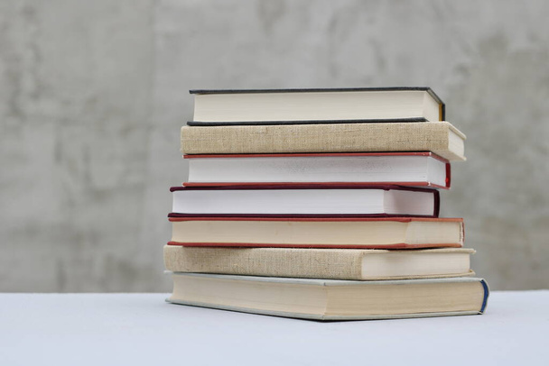 Stack of books on gray background - Zdjęcie, obraz