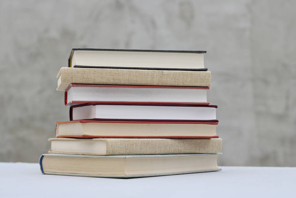 Stack of books on gray background - Zdjęcie, obraz