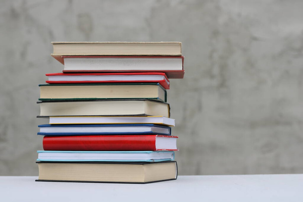 Stack of books on gray background - Foto, imagen