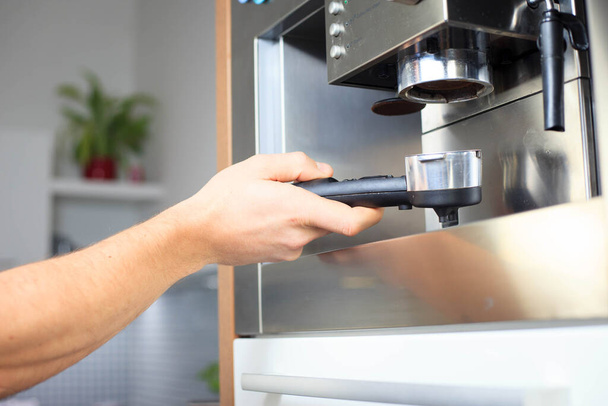 Young man hand preparing a coffee his modern kitchen, coffee time  - 写真・画像