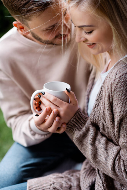 selective focus of cheerful man and girl holding cup  - Φωτογραφία, εικόνα