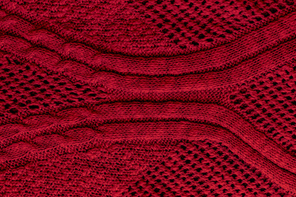 Rojo oscuro, textura de tejido de punto burdeos. Fondo de patrón de suéter áspero. Vista de cerca
 - Foto, imagen