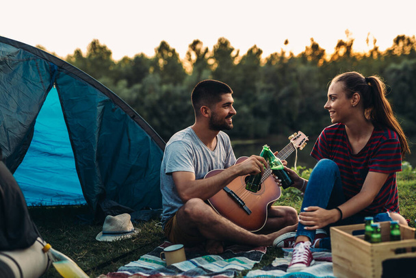 romantic couple on camping together outdoor by the lake - Φωτογραφία, εικόνα
